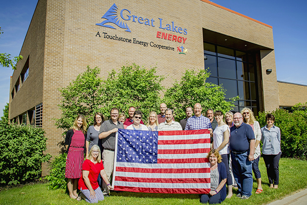 GLE Employees holding an American flag