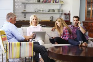 Parents With Adult Offspring Using Digital Devices At Home