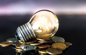 light bulb over pile of coins