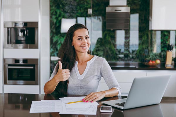 Woman giving thumbs up over new Great Lakes Energy bill format