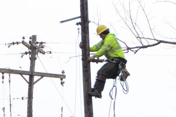 Photo of lineman climbing pole