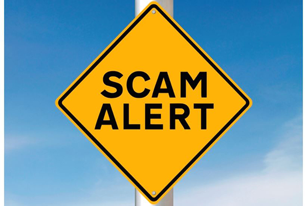 Caution sign that reads Scam Alert