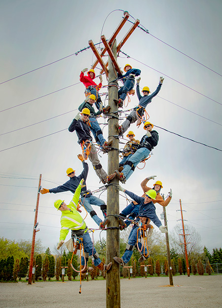 line workers on a telephone pole