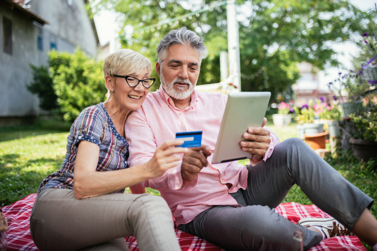 Elderly couple buying online with their card.