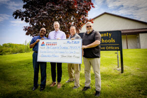 Four men holding a large check for $19,553. 22 from GLE to Tri-County schools for an Energy Wise rebate.