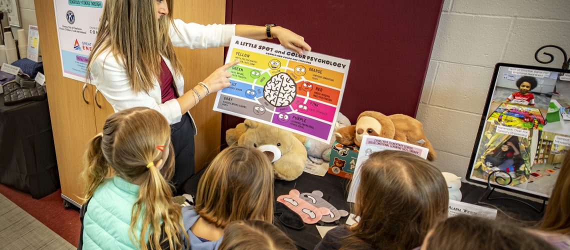 Charlevoix Elementary School Kindergarten Teacher Ericka Mitchell shows students some of the tools in the school's new social-emotional learning library during a recent ribbon-cutting event.