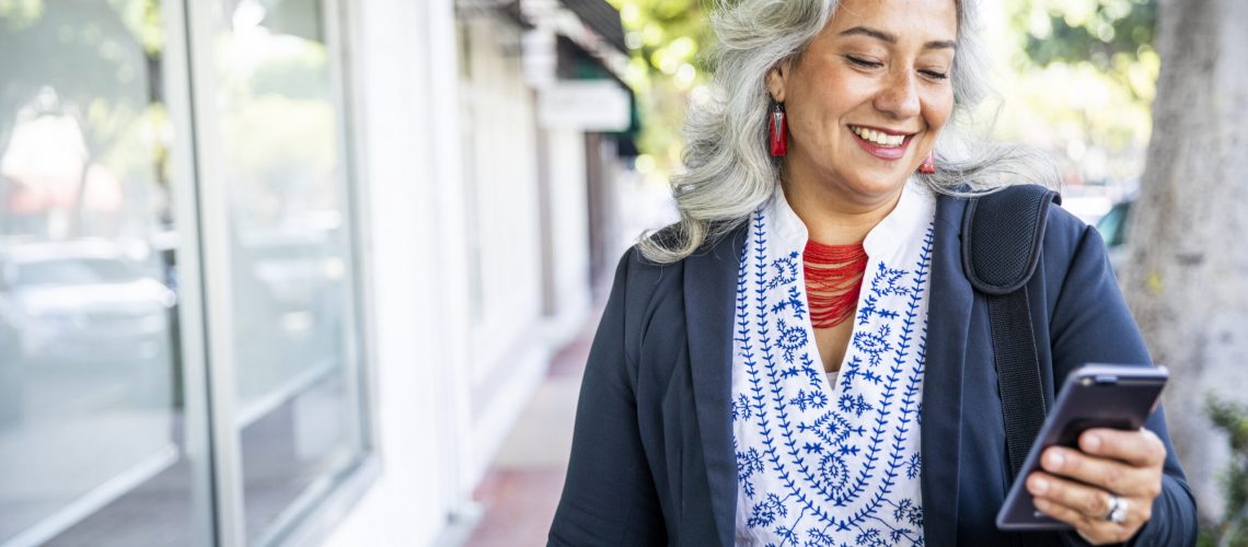 A mature Mexican businesswoman texting