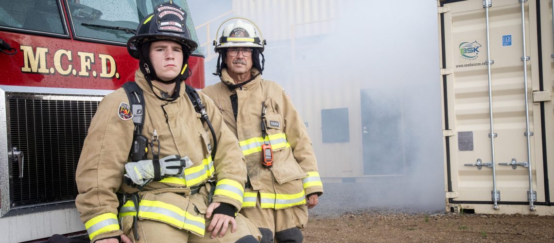 Marion Community Fire Department Assistant Chief
Bruce Tower (right) and firefighter Cody Barron (left) are
pictured outside of the department's recently completed
training facility, partially obscured by simulated smoke.