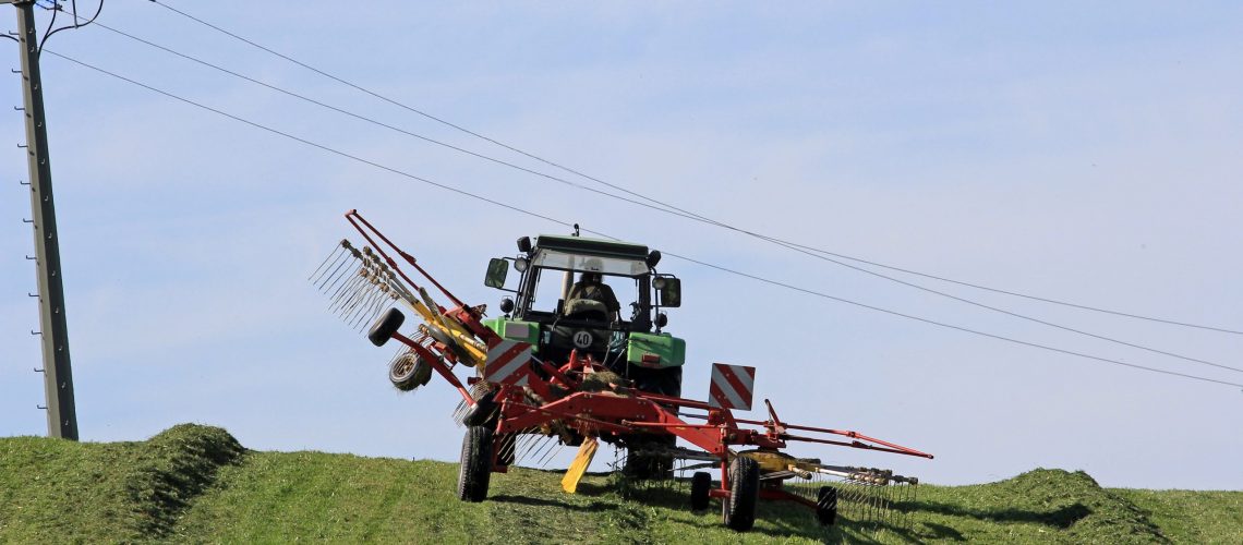 Mowing in the summer on the field. The farm work during the summer