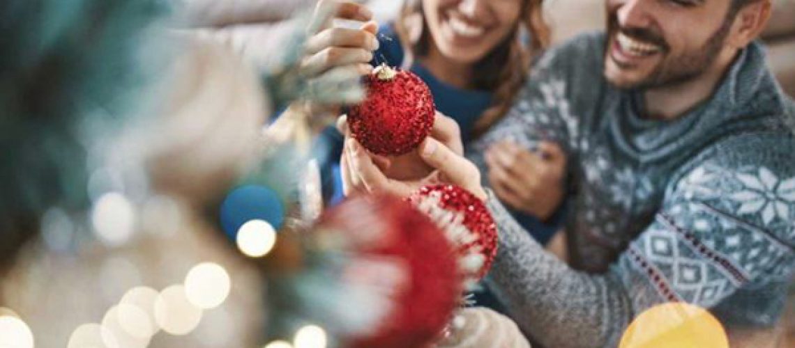 Couple decorating holiday tree