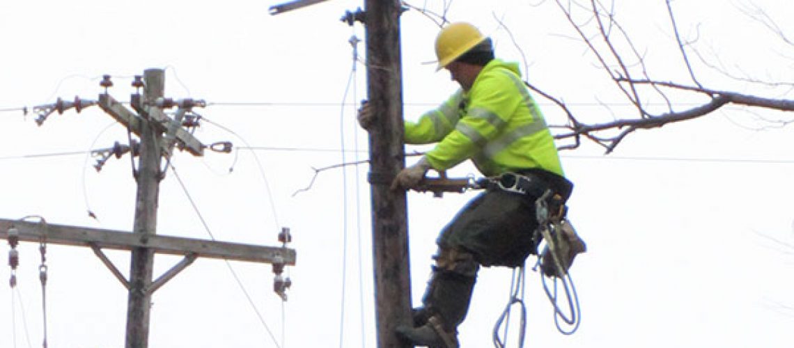 Photo of lineman climbing pole