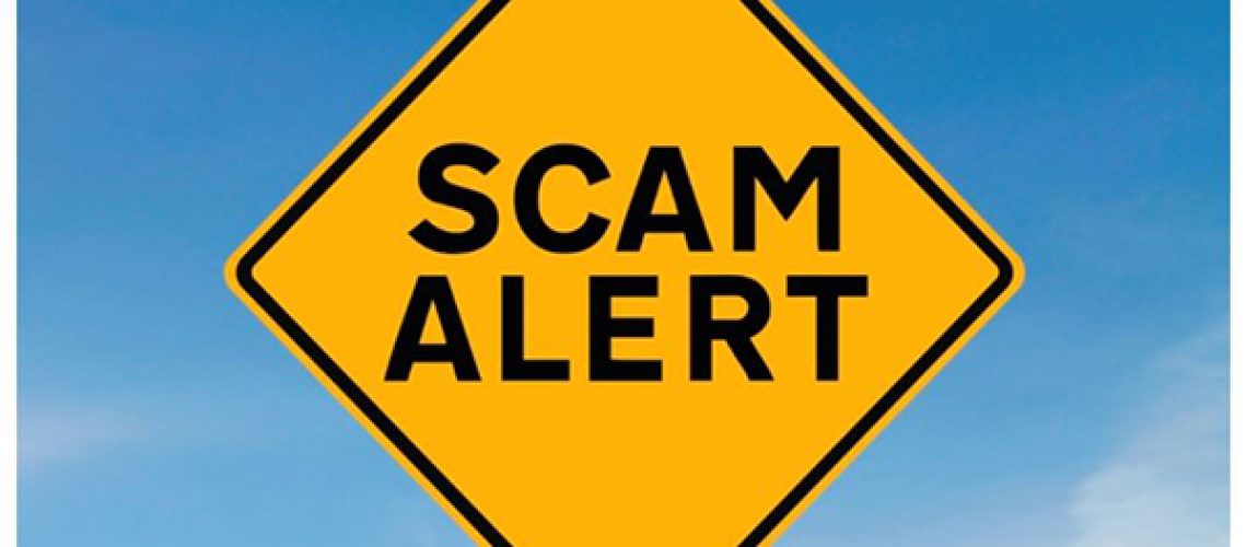 Caution sign that reads Scam Alert